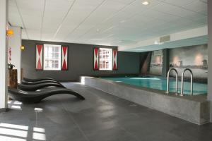 - une grande piscine dans un bâtiment avec piscine dans l'établissement Inntel Hotels Amsterdam Zaandam, à Zaandam