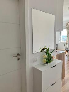 a room with a mirror and a white dresser at Blini Studio Apartment in Pristina