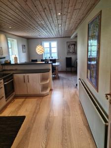 a kitchen with a wooden floor and a dining room at Three bedroom vacation home in Við Gjógv