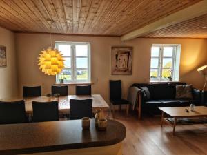 a living room with a table and a couch at Three bedroom vacation home in Við Gjógv