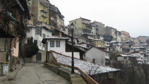 a city street with buildings and a street light at Belivanovi B&B House in Veliko Tŭrnovo