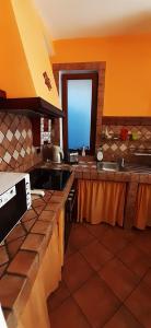 a kitchen with a stove and a window in it at Collina e mare in Camogli