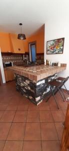 a kitchen with a stone bar in a room at Collina e mare in Camogli