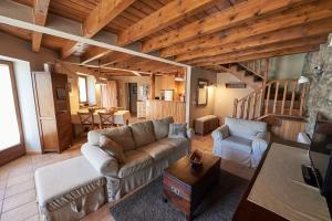 a living room with a couch and chairs and a staircase at Desconnectar Bellver de Cerdanya I in Bellver de Cerdanya 