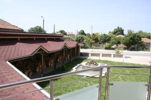 a building with a fence next to a parking lot at Hotel Akre in Kavarna
