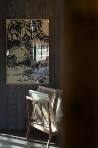 a wooden chair sitting in front of a window at Les Sources de Cheverny in Cheverny