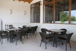a group of tables and chairs in a restaurant at Hotel Akre in Kavarna
