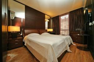 a bedroom with a large white bed in a room at Hotel Akre in Kavarna