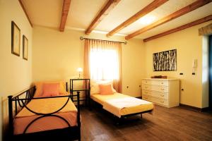 a bedroom with two beds and a dresser and a window at Villa Simone in Žbandaj +11 photos