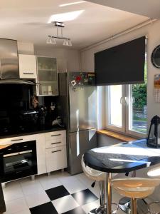 a kitchen with a black and white checkered floor at Lux4u in Szklarska Poręba