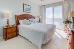 a bedroom with a bed and a large window at Majestic Sun A in Destin