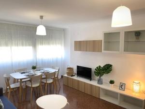 a living room with a table and a dining room at UIM Mediterraneo Diagonal 17 Wifi in Puerto de Sagunto