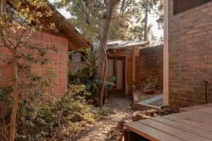 a brick house with a porch and a tree at Descanso Verde in Oberá