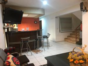 a living room with a bar and a tv at Casa D Miros familias y Grupos y Empresas Max 20 p in Guadalajara