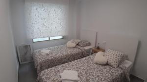Posteľ alebo postele v izbe v ubytovaní Sunset Beach