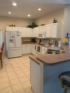 a kitchen with white appliances and white cabinets at Orlando Vacation Villa in Orlando