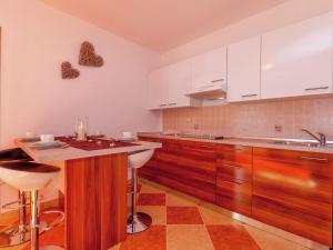 a kitchen with white cabinets and a counter top at Beautiful Apartment in Dramalj in Dramalj