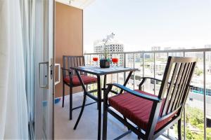 a table and chairs on a balcony with a view at Waikiki Place Studios at The Marine Surf Waikiki in Honolulu