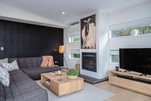 a living room with a couch and a tv at Number 35 in Martinborough