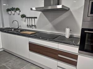 a kitchen with a sink and a stove at "La Villa de Iker" con Piscina, Barbacoa y a 10 mint de Puy du Fou in Argés