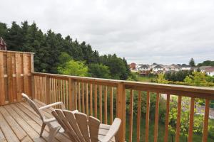 two chairs sitting on the deck of a house at Boardwalk Homes Executive Suites in Kitchener