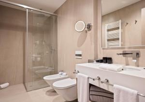 a bathroom with a toilet and a sink and a shower at Hotel AMI Budva Petrovac in Petrovac na Moru