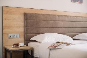 Кровать или кровати в номере Кустос Отель Тверская 