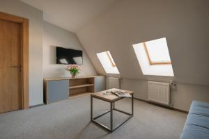 a living room with a table and two skylights at Custos Hotel Tverskaya in Moscow