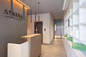 a hallway with a reception desk in a building at Hotel AMI Budva Petrovac in Petrovac na Moru