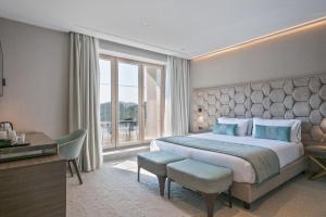 a bedroom with a large bed and a large window at Hotel AMI Budva Petrovac in Petrovac na Moru