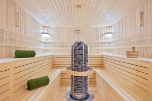 a large empty sauna with wooden floors and ceilings at Hotel AMI Budva Petrovac in Petrovac na Moru