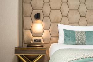 a hotel room with a bed and a nightstand with a bed sidx sidx sidx at Hotel AMI Budva Petrovac in Petrovac na Moru