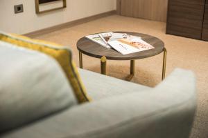 a coffee table with a book on it next to a couch at Hotel AMI Budva Petrovac in Petrovac na Moru