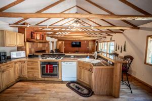 a kitchen with wooden cabinets and a stove top oven at Colorado Bear Creek Cabins in Evergreen
