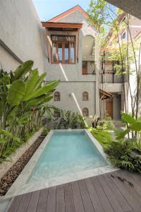 a swimming pool in the backyard of a house at Hidden Garden Hostel in Chiang Mai