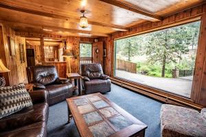 a living room filled with furniture and a fireplace at Colorado Bear Creek Cabins in Evergreen