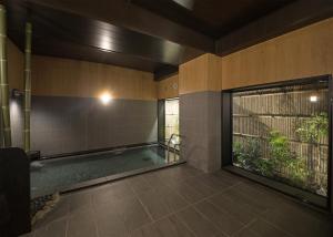 a room with a swimming pool in a building at Hotel Route-Inn Hamada Ekimae in Hamada