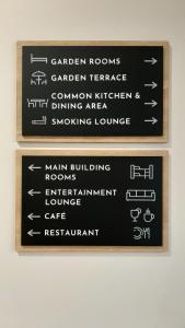 a sign for the garden rooms garden fireplace and dining area at Gallery Hostel in Porto