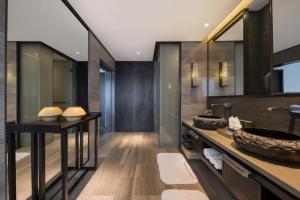 a bathroom with a sink and a mirror at Howard Johnson Sandalwoods Resort Huizhou in Huidong