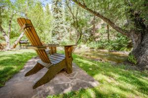 a wooden bench sitting in the middle of a park at Colorado Bear Creek Cabins in Evergreen