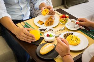 um grupo de pessoas sentadas à mesa a tomar o pequeno-almoço em Gallery Townhouse & Home no Porto