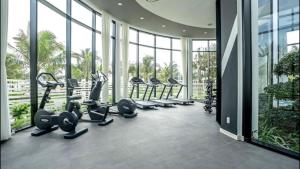 a gym with treadmills and ellipticals in a building at Oceanami 3BR Villa - Vivian Homestay in Long Hai