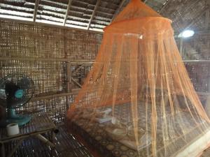 a bedroom with a bed with a net at Varin Village Koh Lipe in Ko Lipe