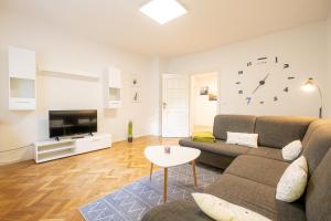 a living room with a couch and a tv at Ferienwohnung zum Wohlfühlen in Essen