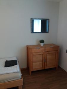 a bedroom with a bed and a dresser with a window at Appartement Confidence in Bürstadt