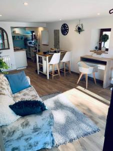 a living room with a couch and a kitchen at L'étape du moulin in Barbaste