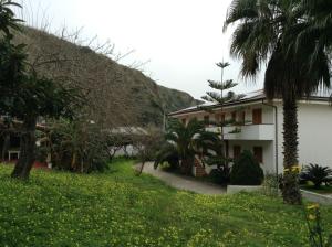 a house in the middle of a field of flowers at Villaggio Camping La Scogliera in Ricadi