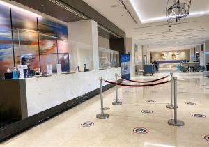 a lobby with a reception counter with a red ribbon at Savoy Hotel Manila in Manila