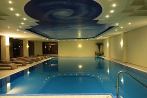 a pool in a hotel with a ceiling with a universe at Wald-Hotel Heppe in Dammbach