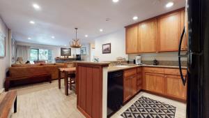 a kitchen with wooden cabinets and a dining room at Mammoth Reservations in Mammoth Lakes